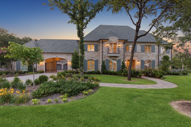 1806 Scenic Cir, Westlake, TX 76262 - french country home with stone siding, a front yard, driveway, and a balcony