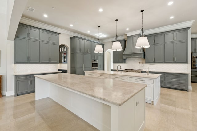 1806 Scenic Cir, Westlake, TX 76262 - kitchen featuring a large island, white oven, crown molding, custom exhaust hood, and decorative backsplash