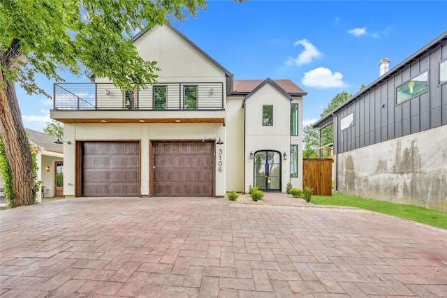 3106 W Jefferson Blvd, Dallas, TX 75211 - view of front of house with a balcony, stucco siding, decorative driveway, and a garage