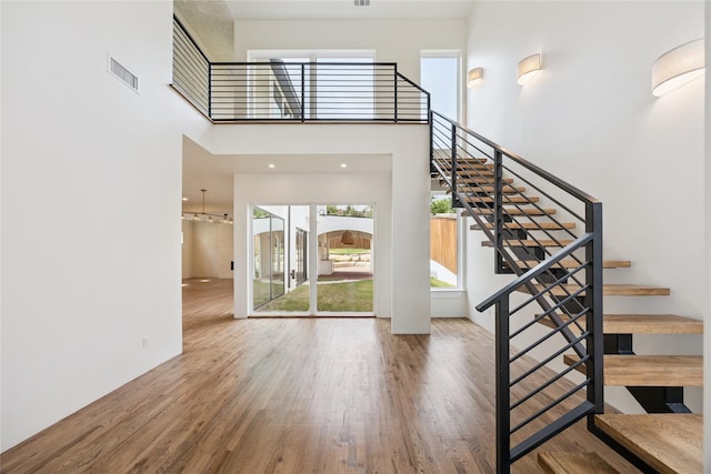 3106 W Jefferson Blvd, Dallas, TX 75211 - stairway with wood finished floors and a towering ceiling