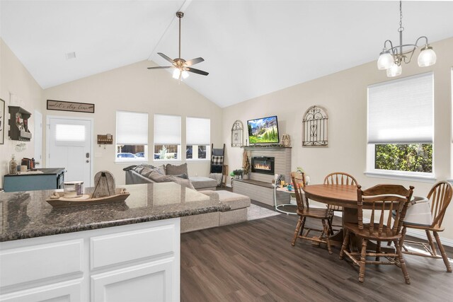 319 W Johnson St, Denison, TX 75020 - living room with dark wood-type flooring, a ceiling fan, plenty of natural light, a glass covered fireplace, and high vaulted ceiling