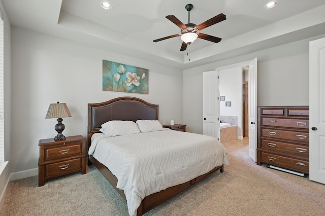 6902 Golf Green Dr, Arlington, TX 76001 - bedroom with a tray ceiling, light carpet, recessed lighting, ensuite bathroom, and a ceiling fan