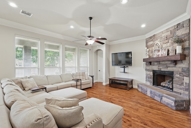 6902 Golf Green Dr, Arlington, TX 76001 - living room featuring crown molding, wood finished floors, arched walkways, a stone fireplace, and recessed lighting