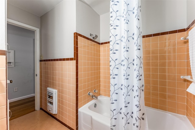 2704 Sunset Ave, Dallas, TX 75211 - bathroom with heating unit, tile walls, shower / tub combo with curtain, wainscoting, and tile patterned floors