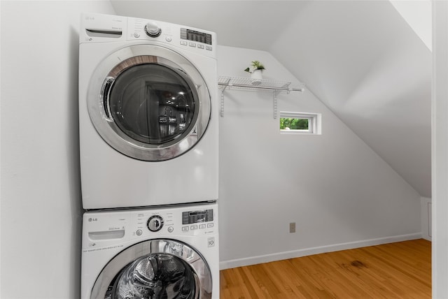 2704 Sunset Ave, Dallas, TX 75211 - laundry area with estacked washer and dryer and wood finished floors