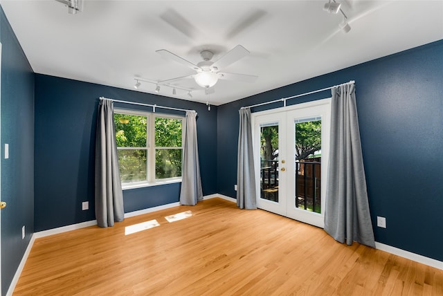 2704 Sunset Ave, Dallas, TX 75211 - empty room featuring track lighting, french doors, a ceiling fan, and plenty of natural light