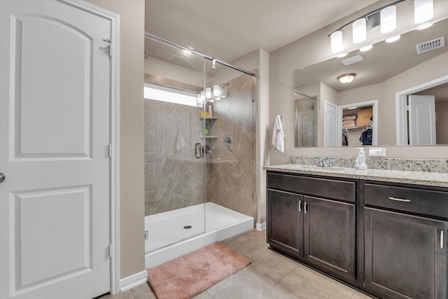 917 N Fork Ranch Rd, Waco, TX 76705 - bathroom featuring tile patterned floors, vanity, a shower stall, and a spacious closet