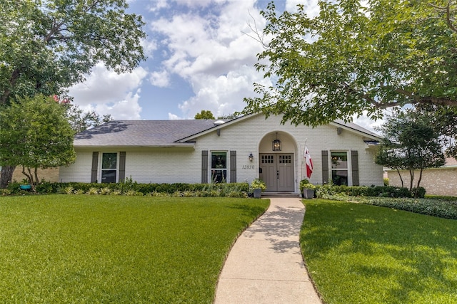 12030 Loch Ness Dr, Dallas, TX 75218 - view of front of house with brick siding, a front lawn, and roof with shingles