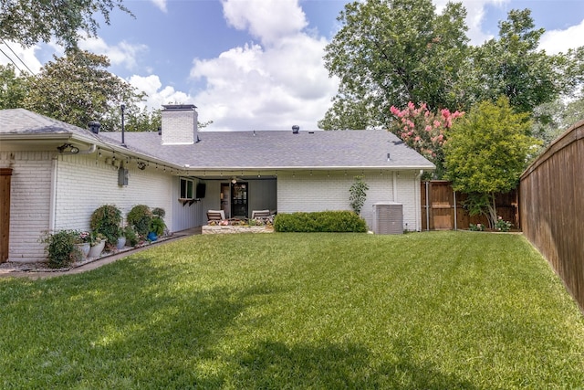 12030 Loch Ness Dr, Dallas, TX 75218 - back of property with brick siding, a fenced backyard, a chimney, and a shingled roof
