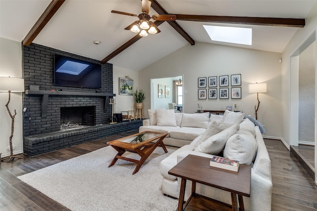 12030 Loch Ness Dr, Dallas, TX 75218 - living area with beam ceiling, a skylight, wood finished floors, a brick fireplace, and a ceiling fan