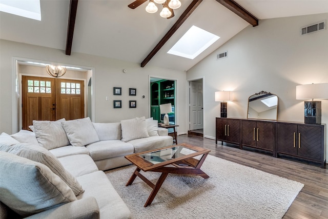 12030 Loch Ness Dr, Dallas, TX 75218 - living area featuring a skylight, a chandelier, beam ceiling, wood finished floors, and high vaulted ceiling