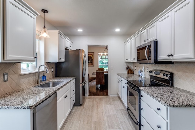 12030 Loch Ness Dr, Dallas, TX 75218 - kitchen with stainless steel appliances, white cabinets, backsplash, recessed lighting, and light stone countertops