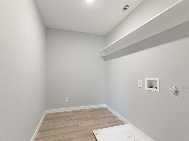 1400 Belzise Ter, Fort Worth, TX 76104 - washroom with washer hookup, light wood finished floors, and gas dryer hookup