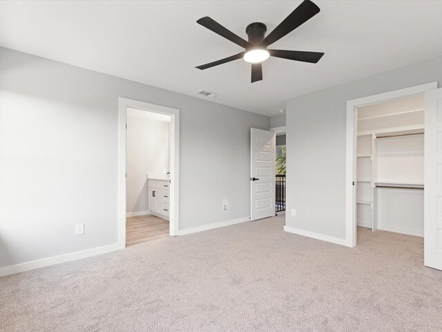 1400 Belzise Ter, Fort Worth, TX 76104 - unfurnished bedroom featuring light colored carpet, a walk in closet, ensuite bath, a ceiling fan, and a closet