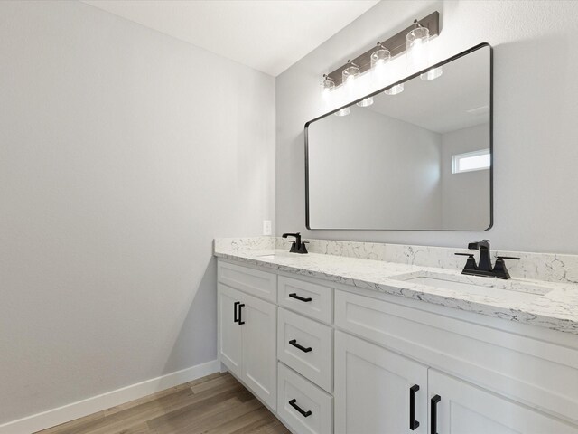 1400 Belzise Ter, Fort Worth, TX 76104 - bathroom featuring double vanity and wood finished floors