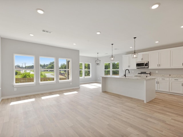 1400 Belzise Ter, Fort Worth, TX 76104 - kitchen with appliances with stainless steel finishes, white cabinets, recessed lighting, light stone countertops, and light wood-style floors
