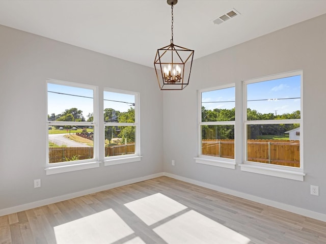 1400 Belzise Ter, Fort Worth, TX 76104 - spare room featuring a chandelier and light wood finished floors