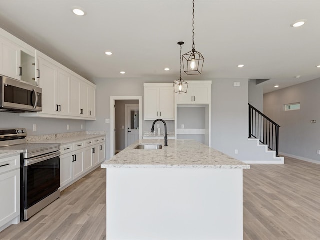 1400 Belzise Ter, Fort Worth, TX 76104 - kitchen with stainless steel appliances, light wood finished floors, light stone countertops, white cabinets, and recessed lighting