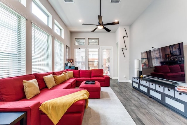735 Red Fork Dr, Lewisville, TX 75056 - living area with wood finished floors, ceiling fan, recessed lighting, and a towering ceiling
