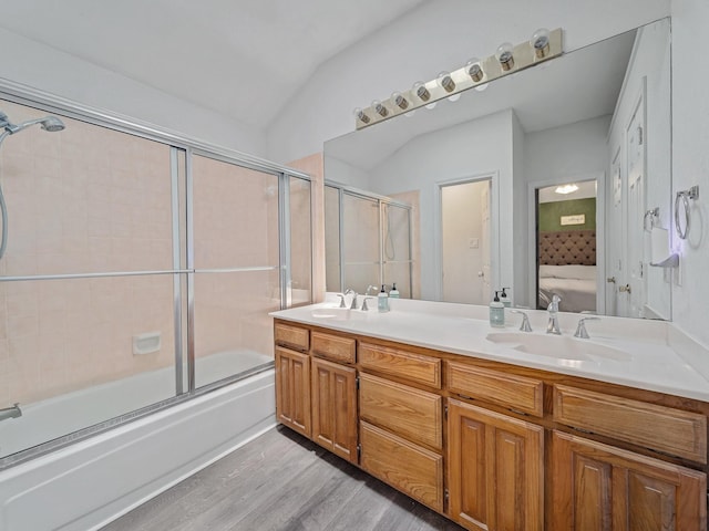 3717 Fairhaven Dr, Fort Worth, TX 76123 - ensuite bathroom featuring wood finished floors, double vanity, shower / bath combination with glass door, and vaulted ceiling