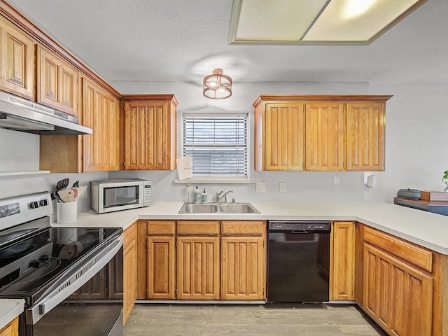 3717 Fairhaven Dr, Fort Worth, TX 76123 - kitchen featuring black dishwasher, electric range, under cabinet range hood, a peninsula, and light wood finished floors