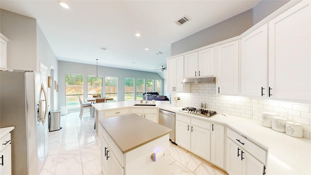 3009 Wood Trl, Flower Mound, TX 75022 - kitchen with light marble finish flooring, appliances with stainless steel finishes, a peninsula, recessed lighting, and backsplash