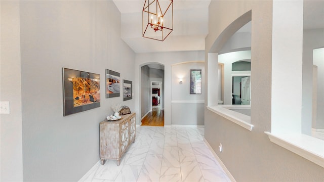 3009 Wood Trl, Flower Mound, TX 75022 - corridor featuring arched walkways, light marble finish flooring, and a chandelier
