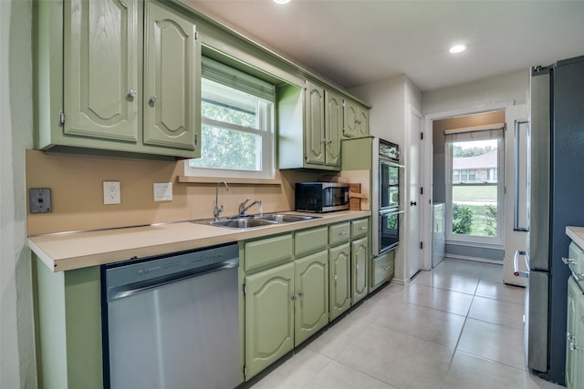 913 Lake Meadows Dr, Rockwall, TX 75087 - kitchen with green cabinetry, appliances with stainless steel finishes, light countertops, light tile patterned flooring, and recessed lighting
