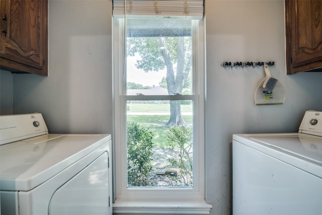 913 Lake Meadows Dr, Rockwall, TX 75087 - laundry room with washing machine and clothes dryer, cabinet space, and plenty of natural light