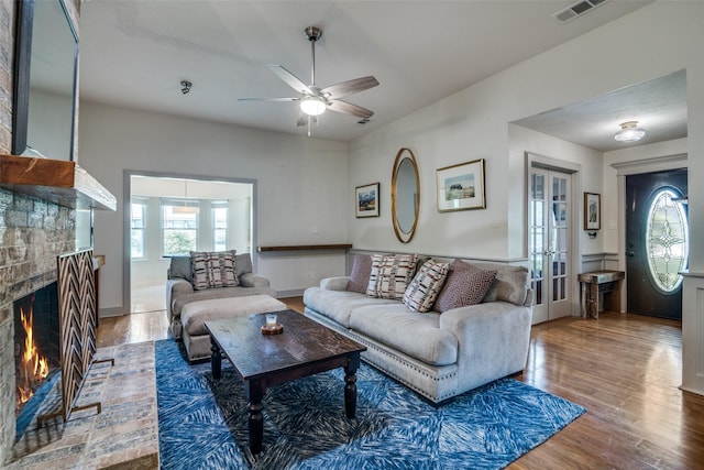 913 Lake Meadows Dr, Rockwall, TX 75087 - living room featuring ceiling fan, wood finished floors, a fireplace, and french doors
