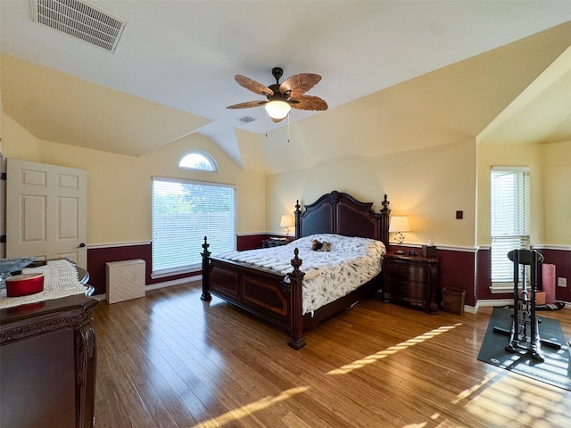 14001 Zippo Way, Fort Worth, TX 76052 - bedroom featuring multiple windows, wood finished floors, wainscoting, vaulted ceiling, and a ceiling fan