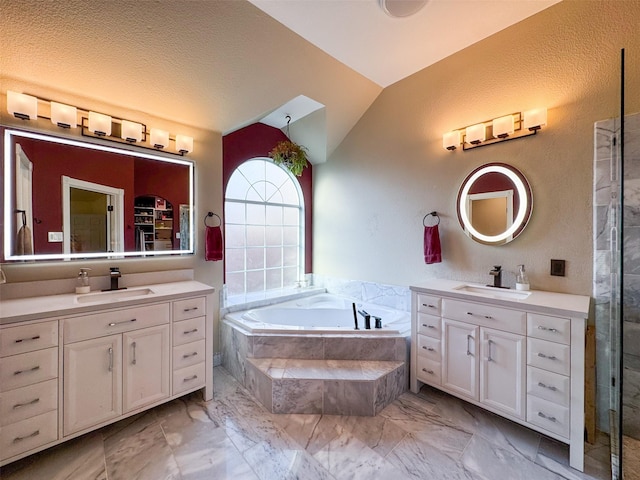 14001 Zippo Way, Fort Worth, TX 76052 - bathroom featuring vaulted ceiling, two vanities, a bath, and marble look tiles