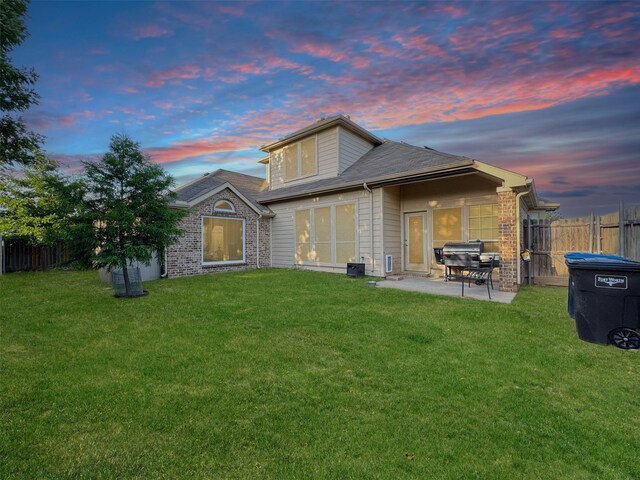 14001 Zippo Way, Fort Worth, TX 76052 - back of property at dusk featuring a patio area and brick siding