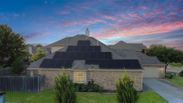 14001 Zippo Way, Fort Worth, TX 76052 - view of front of house with brick siding, a shingled roof, concrete driveway, a chimney, and solar panels