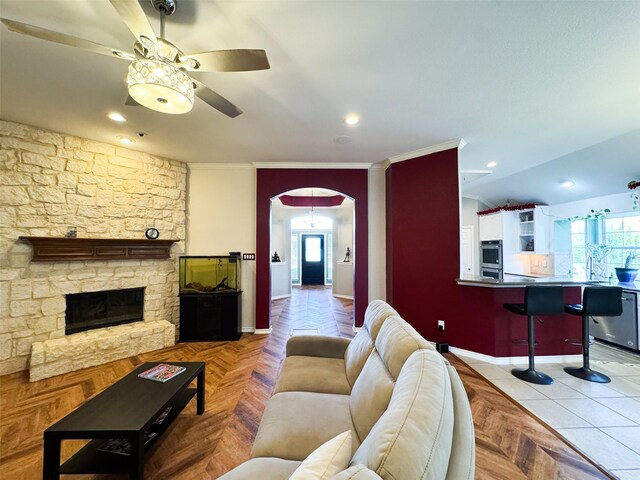 14001 Zippo Way, Fort Worth, TX 76052 - living area featuring ceiling fan, arched walkways, healthy amount of natural light, a fireplace, and crown molding