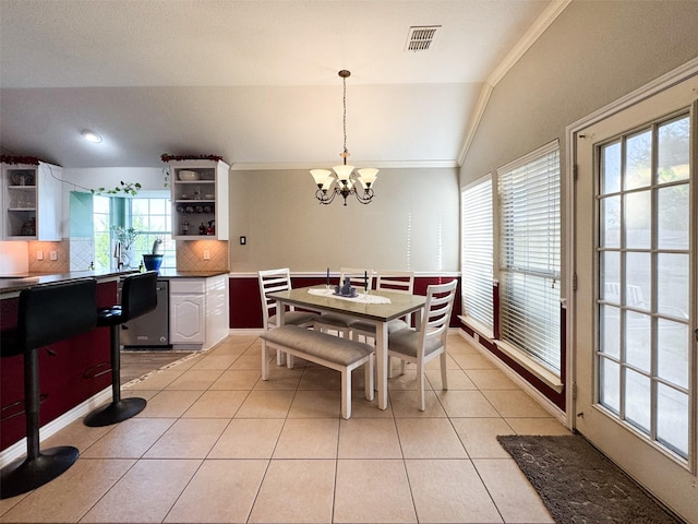14001 Zippo Way, Fort Worth, TX 76052 - dining room featuring vaulted ceiling, plenty of natural light, a chandelier, light tile patterned flooring, and ornamental molding