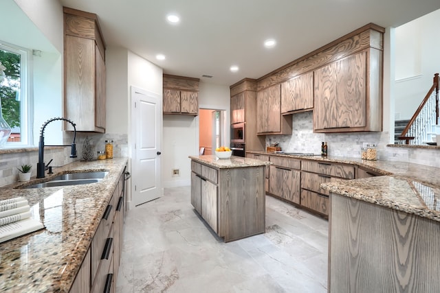 3609 Whitehaven Dr, Plano, TX 75093 - kitchen with stainless steel oven, backsplash, recessed lighting, black electric cooktop, and light stone countertops