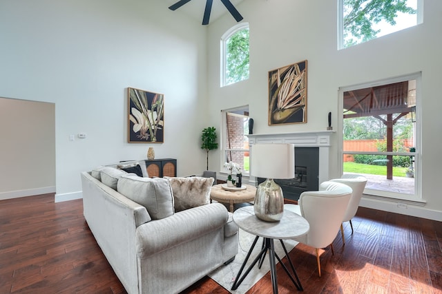 3609 Whitehaven Dr, Plano, TX 75093 - living area featuring a towering ceiling, ceiling fan, dark wood-style floors, and a glass covered fireplace