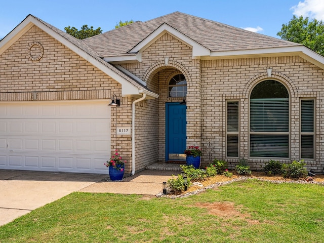 5117 Forest Lawn Dr, Mckinney, TX 75071 - view of front facade with brick siding, roof with shingles, a front yard, and an attached garage