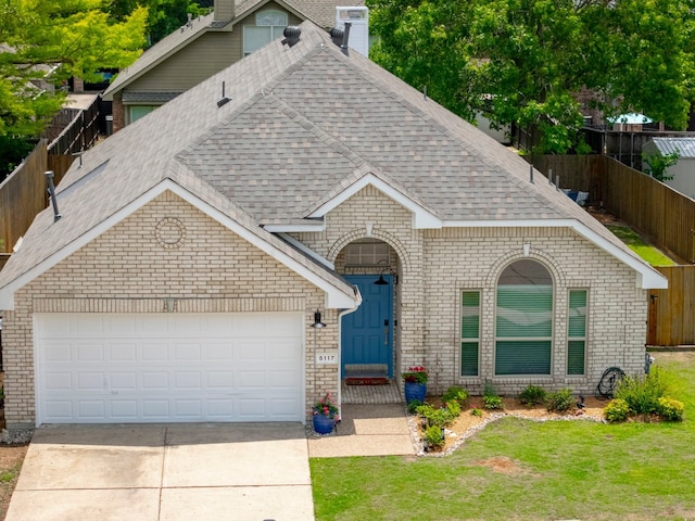 5117 Forest Lawn Dr, Mckinney, TX 75071 - view of front of home featuring a shingled roof, brick siding, concrete driveway, a garage, and a chimney