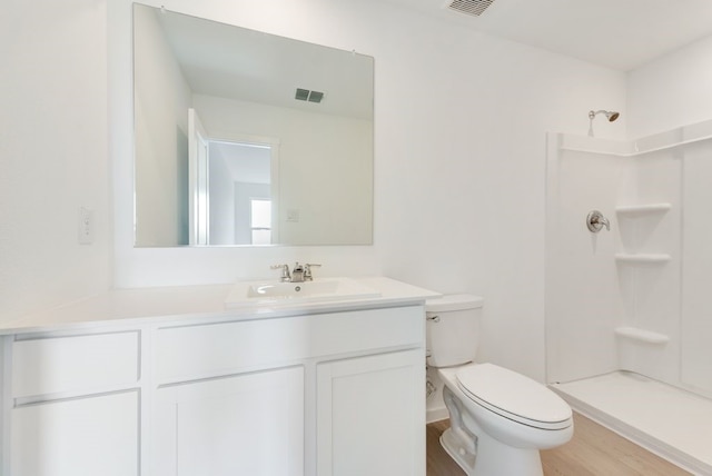 7754 Reese St, Dallas, TX 75114 - bathroom featuring vanity, a shower, and wood finished floors