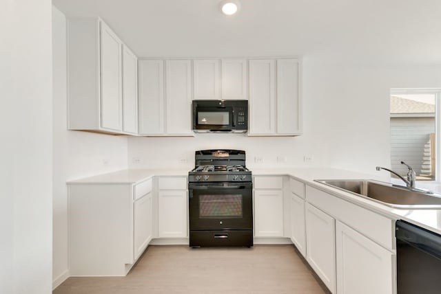 7754 Reese St, Dallas, TX 75114 - kitchen featuring black appliances, white cabinets, light countertops, light wood-style flooring, and recessed lighting