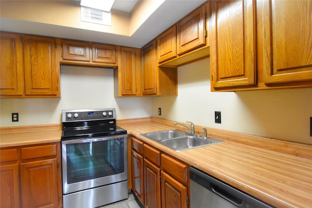 1704 Baird Farm Cir Unit 4207, Arlington, TX 76006 - kitchen featuring stainless steel appliances, light countertops, and brown cabinetry