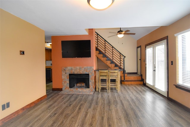 1704 Baird Farm Cir Unit 4207, Arlington, TX 76006 - unfurnished living room with wood finished floors, stairway, a ceiling fan, a tile fireplace, and plenty of natural light