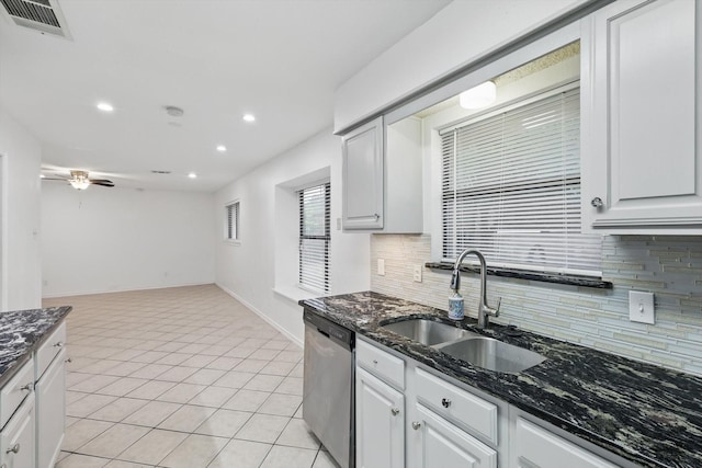 813 Leslie Ln, Coppell, TX 75019 - kitchen with stainless steel dishwasher, backsplash, recessed lighting, ceiling fan, and dark stone countertops