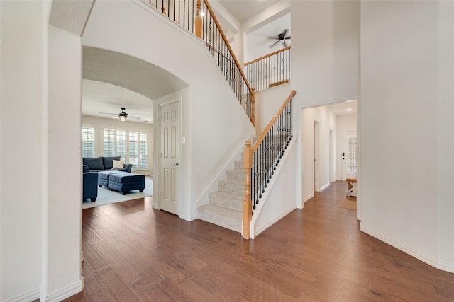 1021 Springtown St, Forney, TX 75126 - stairway with ceiling fan, arched walkways, wood finished floors, and a high ceiling