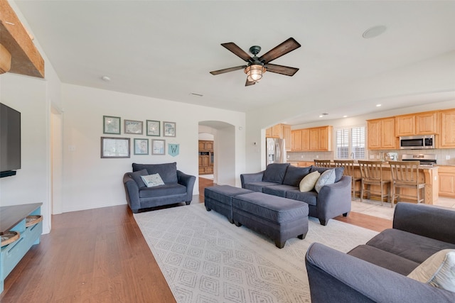1021 Springtown St, Forney, TX 75126 - living room featuring arched walkways, a ceiling fan, light wood-style flooring, and recessed lighting