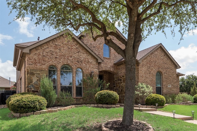 1021 Springtown St, Forney, TX 75126 - view of front facade featuring brick siding, a front yard, and stone siding