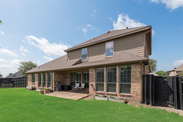 1021 Springtown St, Forney, TX 75126 - back of house featuring brick siding, a patio, a gate, and a shingled roof