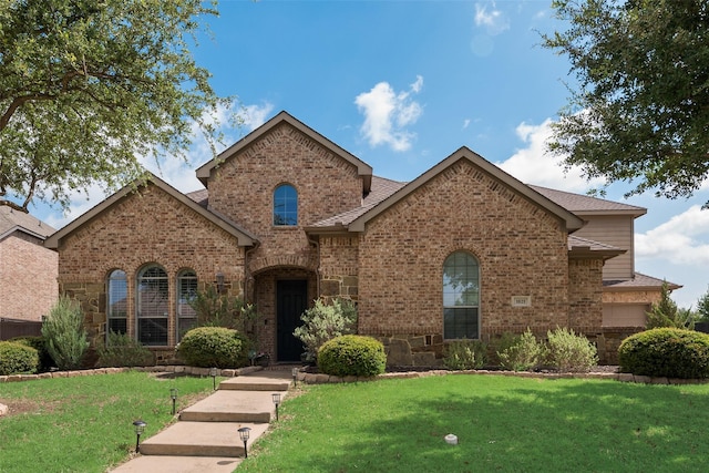 1021 Springtown St, Forney, TX 75126 - view of front of home with a front yard, brick siding, and stone siding